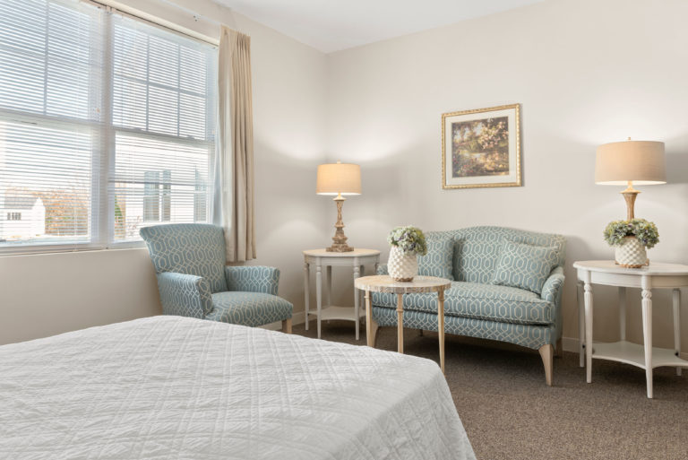 Bedroom with sitting area in a senior living apartment