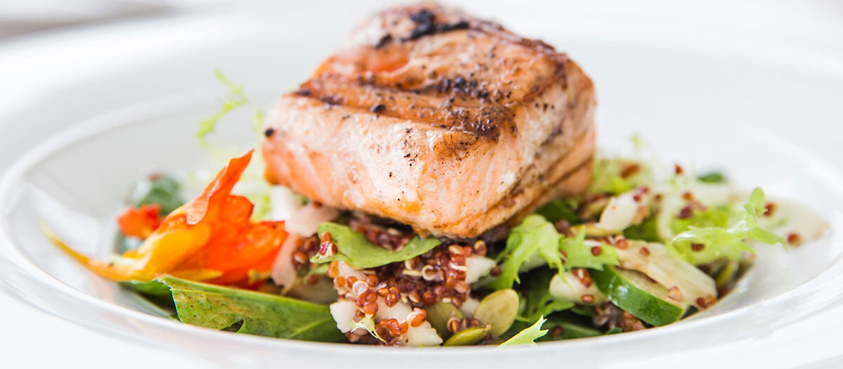 Cooked fish over vegetables