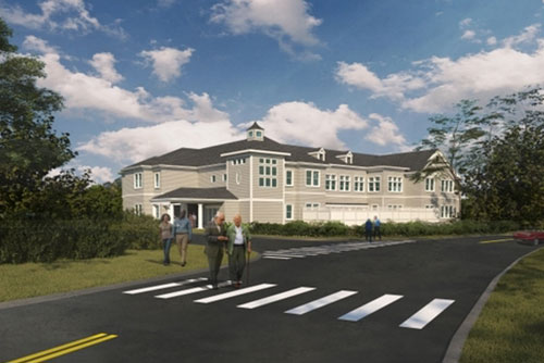 Exterior of Duxbury House Memory Care Residence with people walking across the street