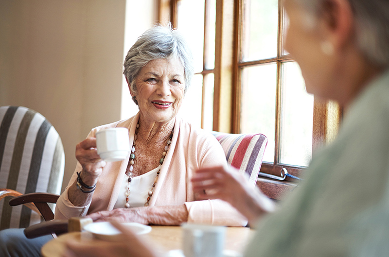 Two women chatting over coffee