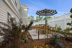 Fenced-in backyard patio at Duxbury House