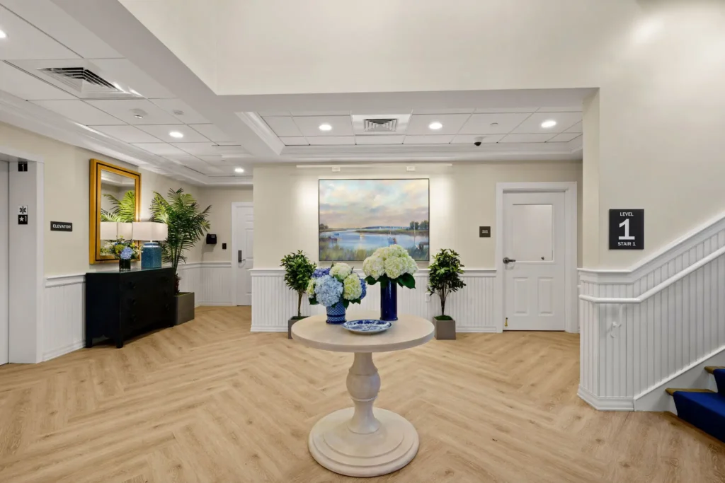 Table with blue and white hydrangea arrangements in the Duxbury House lobby