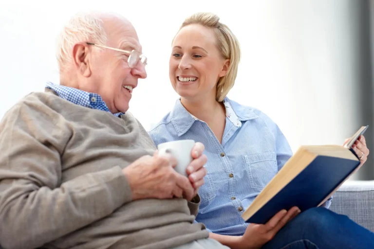 Caregiver Talking To Senior Man at Memory Care Community