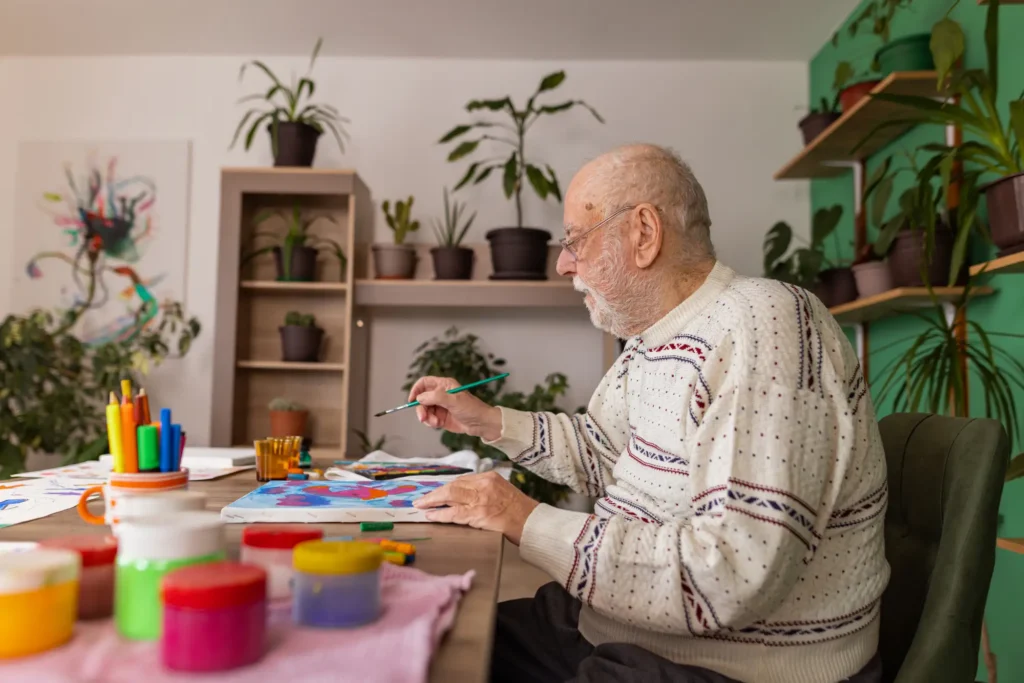 senior working on art project